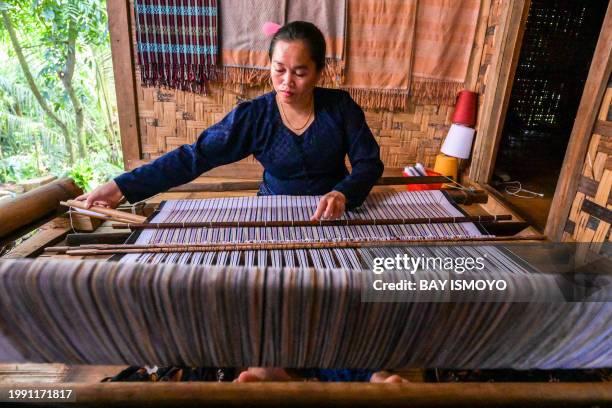 This picture taken on January 25, 2024 shows a member of the Indigenous Baduy tribe using a traditional weaving machine in Kanekes Village in Lebak,...