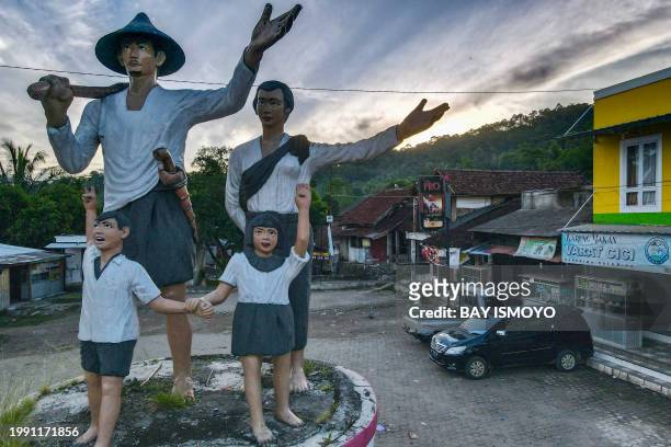 This picture taken on January 26, 2024 shows an aerial view a statue depicting a family of the Indigenous Baduy tribe at the entrance to Kanekes...