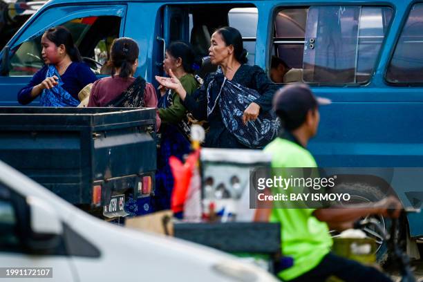 This picture taken on January 25, 2024 shows Baduy villagers using public transportation as they return from their fields in Kanekes Village in...