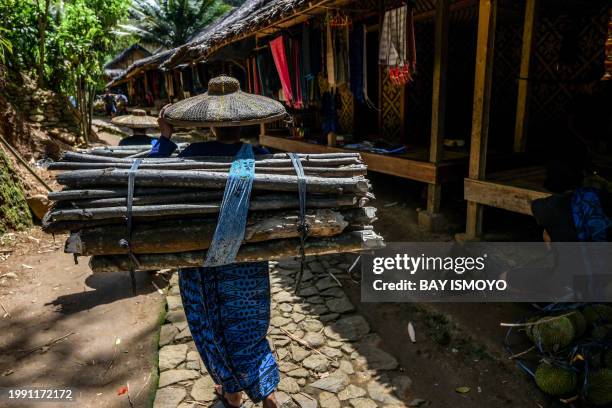 This picture taken on January 25, 2024 shows members of the Indigenous Baduy tribe returning from their fields in Kanekes Village in Lebak, Banten...