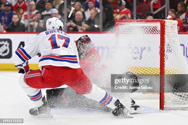 Goaltender Petr Mrazek of the Chicago Blackhawks makes a save on a shot from Blake Wheeler of the New York Rangers in the first period on February...