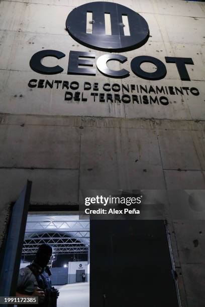 Police officer with the face covered opens the front door at CECOT in Tecoluca on February 6, 2024 in San Vicente, El Salvador. On February of 2023...