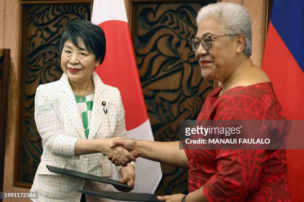 Japan's Minister of Foreign Affairs Yoko Kamikawa shakes hands with Samoa's Prime Minister Afioga Fiame Naomi Mata'afa during a signing ceremony in...