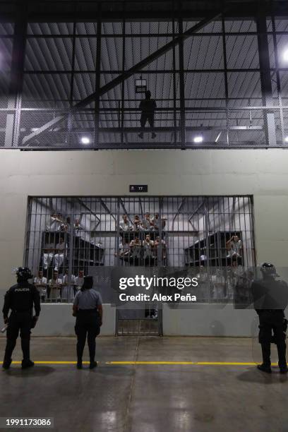 Police officers wearing riot gear stand on patrol inside a cell at CECOT in Tecoluca on February 6, 2024 in San Vicente, El Salvador. On February of...