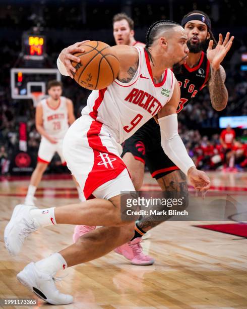 Dillon Brooks of the Houston Rockets dribbles against Gary Trent Jr. #33 of the Toronto Raptors during the second half of their basketball game at...
