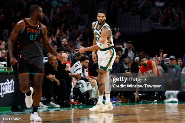 Jayson Tatum of the Boston Celtics holds out three fingers after hitting a three point basket during the second half against the Washington Wizards...