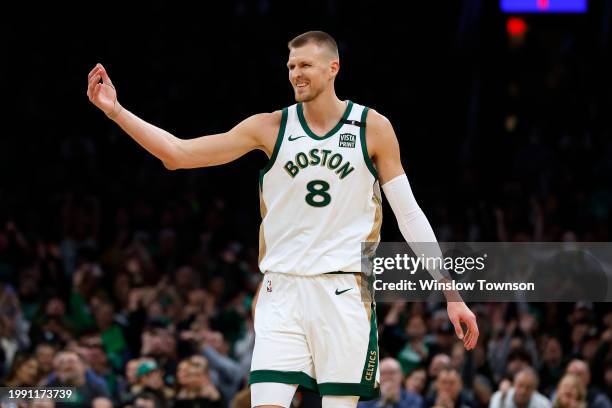 Kristaps Porzingis of the Boston Celtics smiles at his bench after hitting a three point basket against the Washington Wizards during the second half...