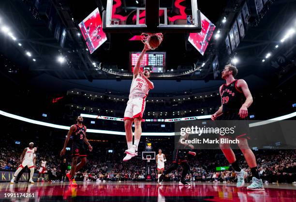 Alperen Sengun of the Houston Rockets goes to the basket against Jakob Poeltl of the Toronto Raptors during the first half of their basketball game...