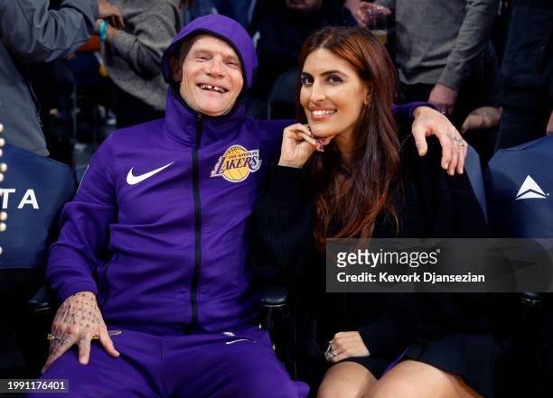 Red Hot Chili Peppers band member Flea and Melody Ehsani attend the basketball game between the Los Angeles Lakers and the New Orleans Pelicans at...