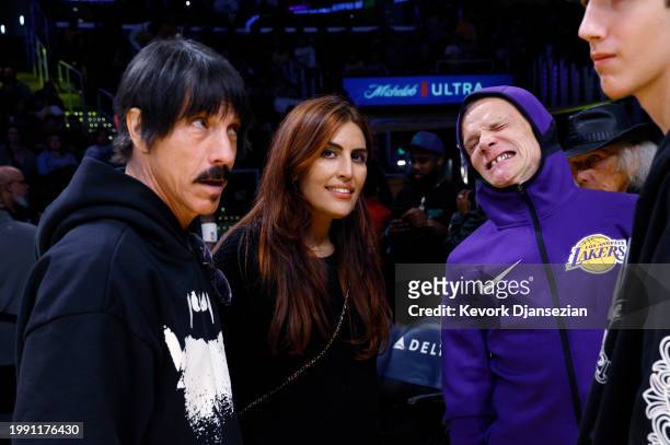 Red Hot Chili Peppers band members Anthony Kiedis Flea and Melody Ehsani attend the basketball game between the Los Angeles Lakers and the New...