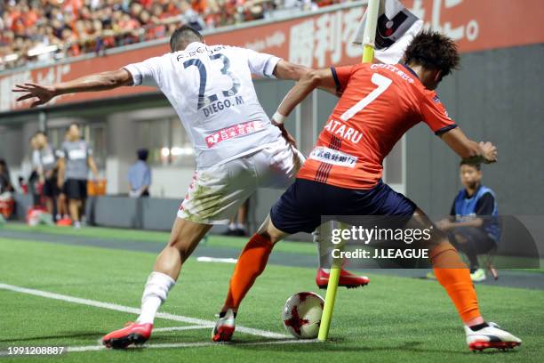 Ataru Esaka of Omiya Ardija and Diego Macedo of Consadole Sapporo compete for the ball during the J.League J1 match between Omiya Ardija and Hokkaido...