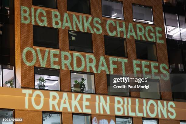 Government Watchdog Accountable.US projects a graphic onto the Consumer Bankers Association HQ to highlight alleged big bank profiteering via...