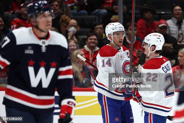 Nick Suzuki of the Montreal Canadiens celebrates with teammates after scoring his second goal of the game against the Washington Capitals during the...