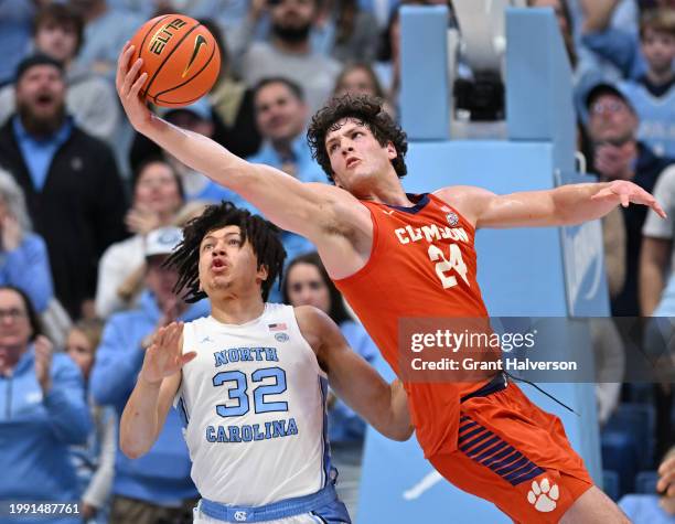 Hall of the Clemson Tigers catches an entry pass against James Okonkwo of the North Carolina Tar Heels in the second half at the Dean E. Smith Center...