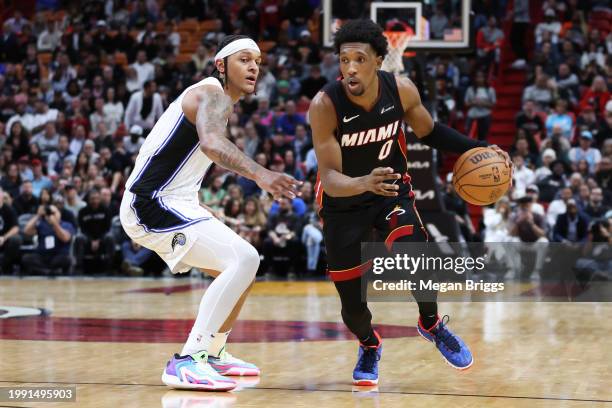 Josh Richardson of the Miami Heat drives against Paolo Banchero of the Orlando Magic during the fourth quarter at Kaseya Center on February 06, 2024...