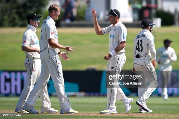 Kyle Jamieson and Tim Southee of New Zealand celebrate after dismissing David Bedingham during day four of the First Test in the series between New...