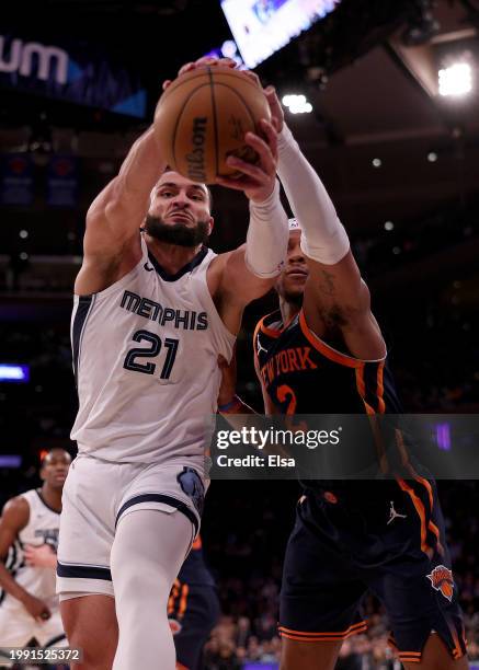 David Roddy of the Memphis Grizzlies tries to hang on to the ball as Miles McBride of the New York Knicks defends in the second half at Madison...