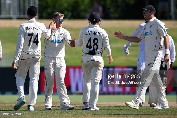 Glenn Phillips of New Zealand celebrates with his team after dismissing Clyde Fortuin during day four of the First Test in the series between New...