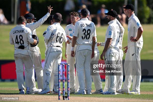 Mitchell Santner of New Zealand celebrates with his team after dismissing Tshepo Moreki during day four of the First Test in the series between New...