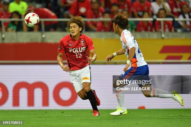 Toshiyuki Takagi of Urawa Red Diamonds controls the ball against Yuto Horigome of Albirex Niigata during the J.League J1 match between Urawa Red...