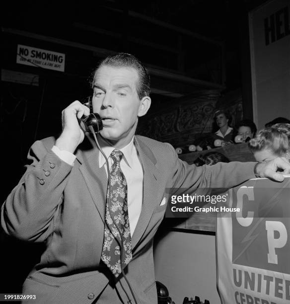American actor Fred MacMurray answers a call during the United Cerebral Palsy telethon, at the studios of KECA-TV in Los Angeles, California, 16th...