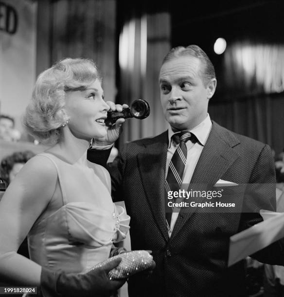 Hungarian-American actress and socialite Zsa Zsa Gabor answers one caller, as British-born American comedian and actor Bob Hope holds the receiver,...