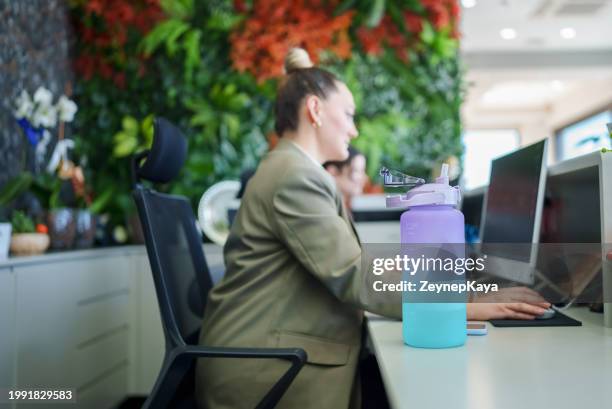 pregnant woman using water bottle at work - reusable stock pictures, royalty-free photos & images