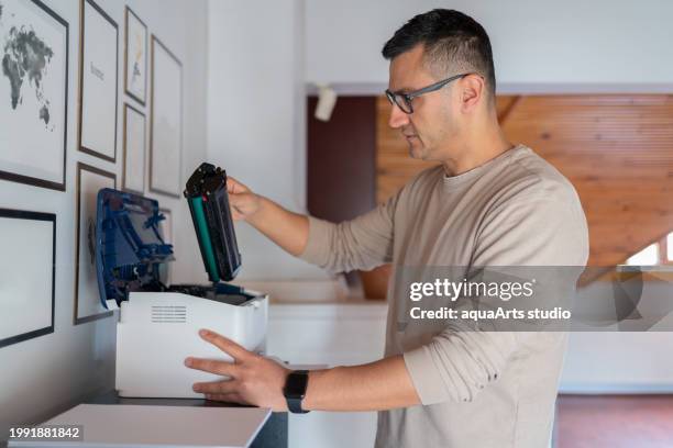 man change the printer toner at home - inkjet cartridge stock pictures, royalty-free photos & images