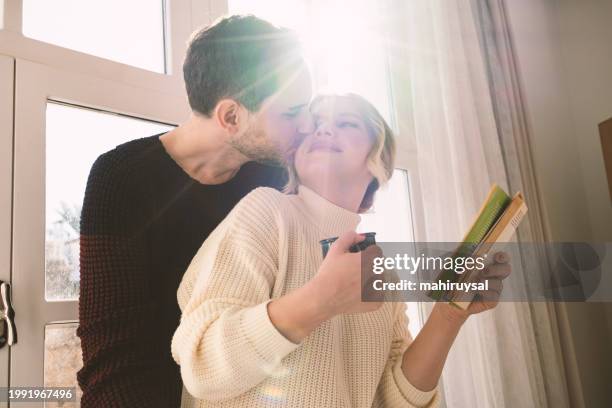 lovely couple - woman blond looking left window stockfoto's en -beelden