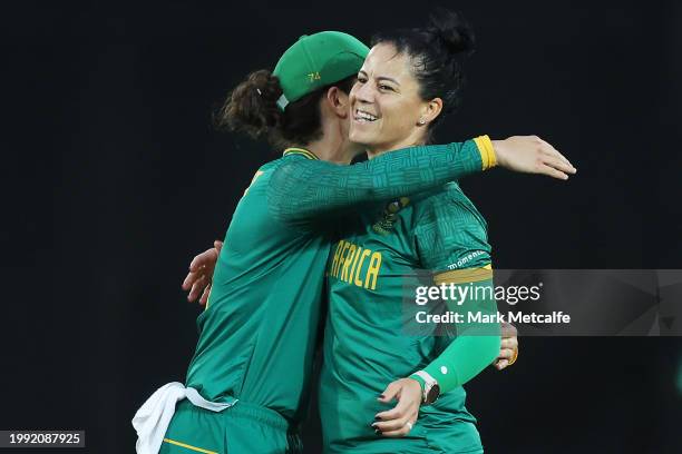 Marizanne Kapp of South Africa celebrates with Laura Wolvaardt of South Africa after taking the wicket of Beth Mooney of Australia during game two of...