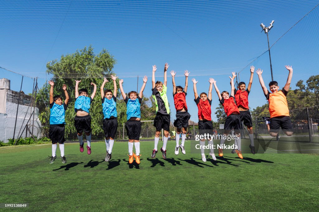 Youth Soccer Team Celebrating Victory on Sunny Field