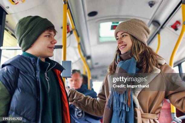 two teenage kids travelling by bus in warsaw, poland - warsaw bus stock pictures, royalty-free photos & images