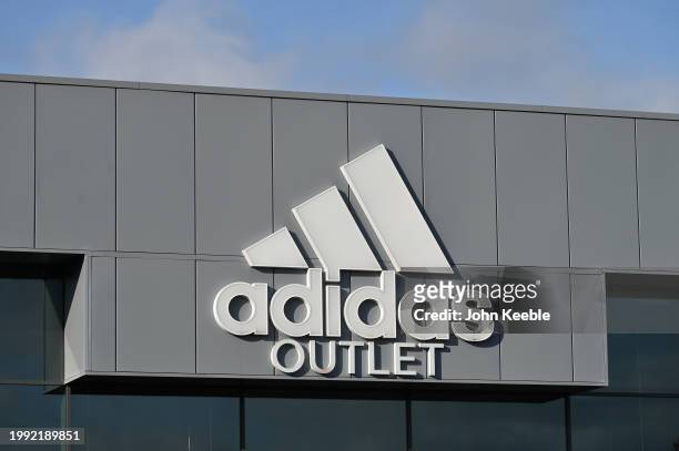 General view of a adidas Outlet Sportswear retail store sign at Lakeside Retail Park on February 5, 2024 in Grays, United Kingdom.