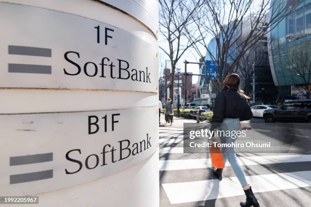 Pedestrian walks past a SoftBank branch on February 07, 2024 in Tokyo, Japan. SoftBank Group Corp. Is a Japanese multinational holding company that...