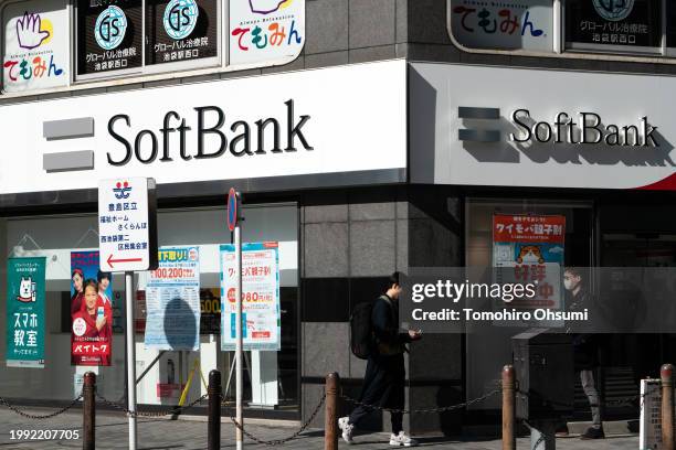 Pedestrians walk past a SoftBank branch on February 07, 2024 in Tokyo, Japan. SoftBank Group Corp. Is a Japanese multinational holding company that...