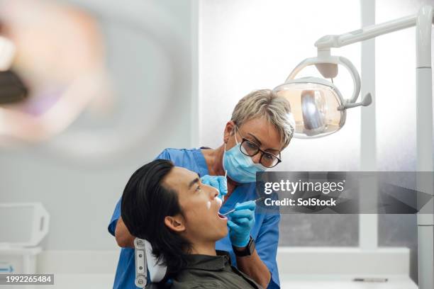 teeth looking great - surgical mask and gloves stock pictures, royalty-free photos & images