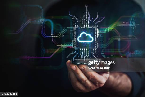 digital cloud technology in your hand. male hand holding futuristic cloud chip in the center and circuit board with vibrant data transfers, representing evolving technology of the future. - cloud-computing stockfoto's en -beelden