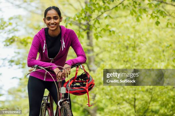 confident woman with her bicycle - cycling helmet stock pictures, royalty-free photos & images