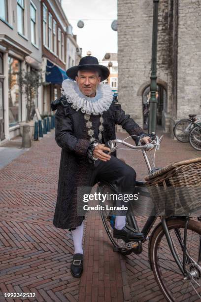 portrait of a tour guide mayor hoogenhouck in delft on a bike - 17th century style stock pictures, royalty-free photos & images