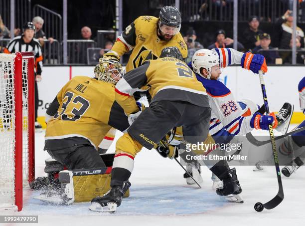 Connor Brown of the Edmonton Oilers attempts a shot against Adin Hill, Nicolas Hague and Zach Whitecloud of the Vegas Golden Knights in the third...