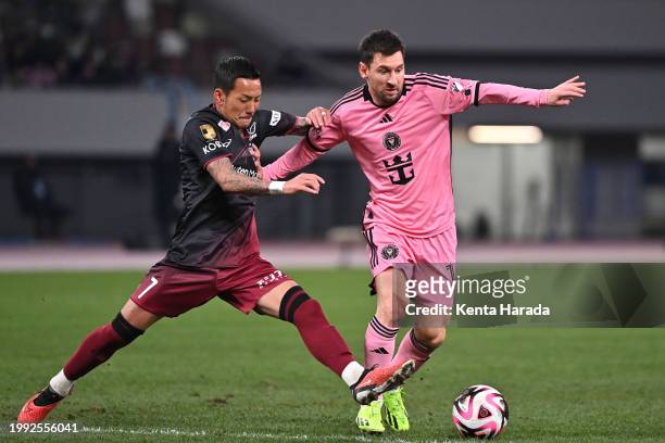 Yosuke Ideguchi of Vissel Kobe and Lionel Messi of Inter Miami compete for the ball during the preseason friendly match between Vissel Kobe and Inter...