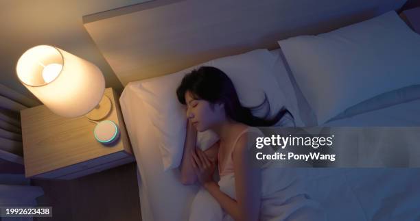 asian woman use white noise - music machines stock pictures, royalty-free photos & images