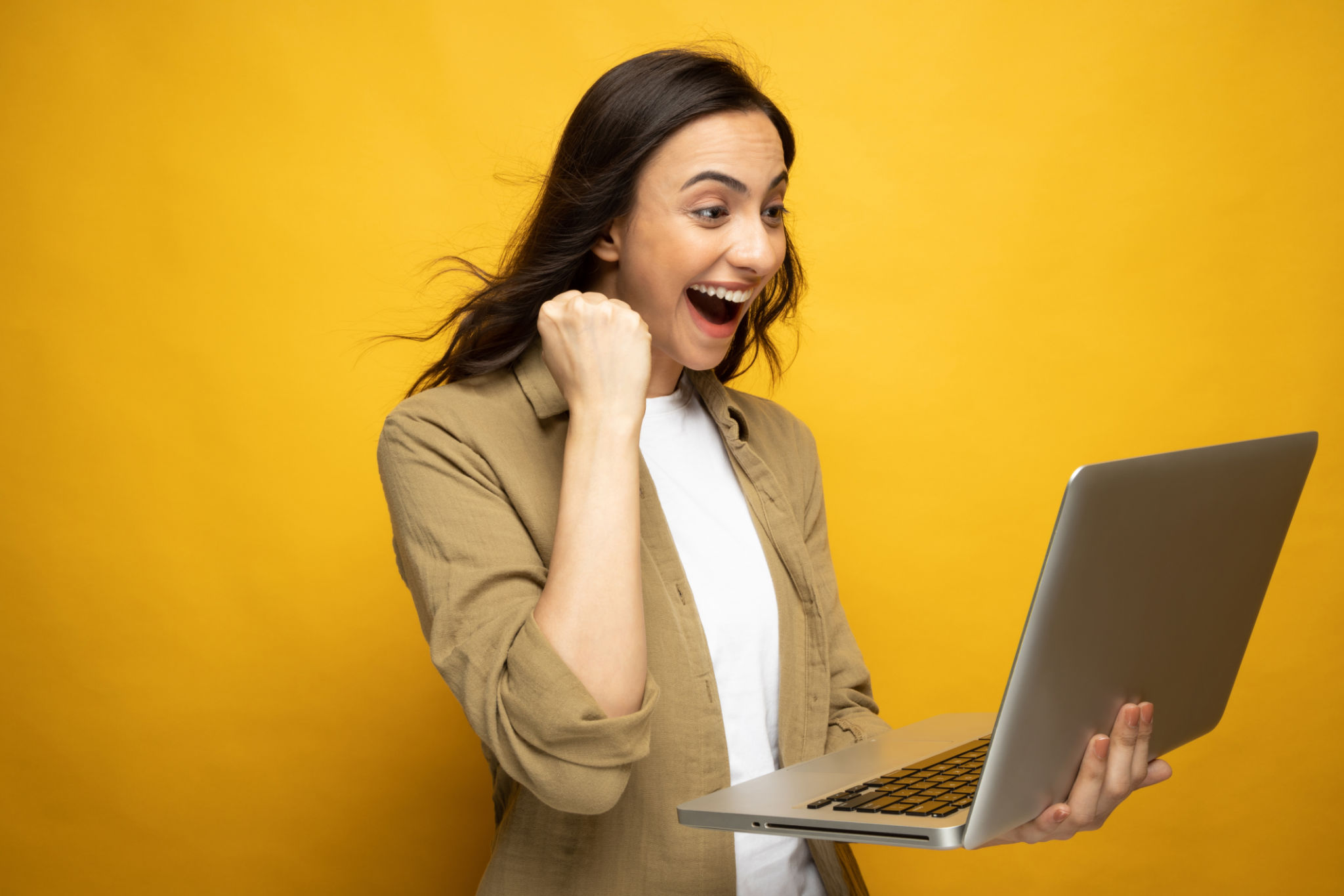 Portrait of young woman using laptop isolated yellow background stock photo Portrait of young woman using laptop isolated yellow background stock photo