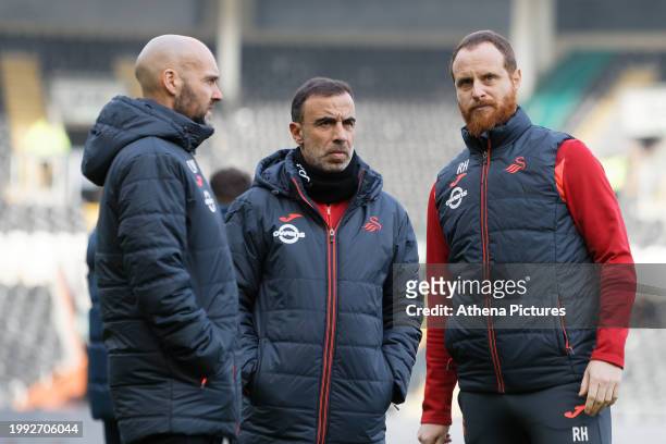 Swansea City manager Luke Williams speaks with Ryan Harley, assistant head coach prior to the Sky Bet Championship match between Hull City and...