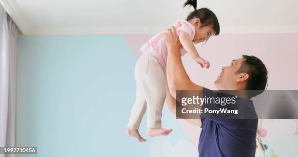 asian father hold high kid - accompanying stock pictures, royalty-free photos & images
