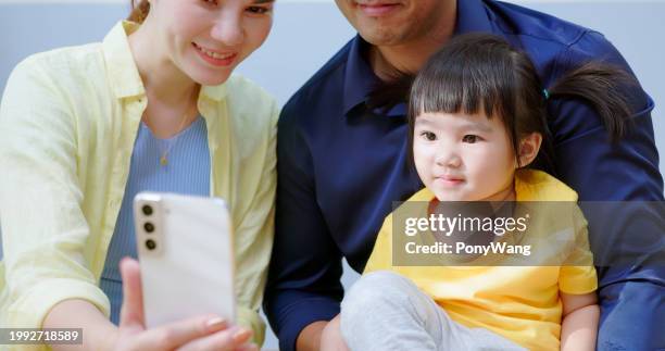 asian parent accompany kid mobile - accompanying stock pictures, royalty-free photos & images