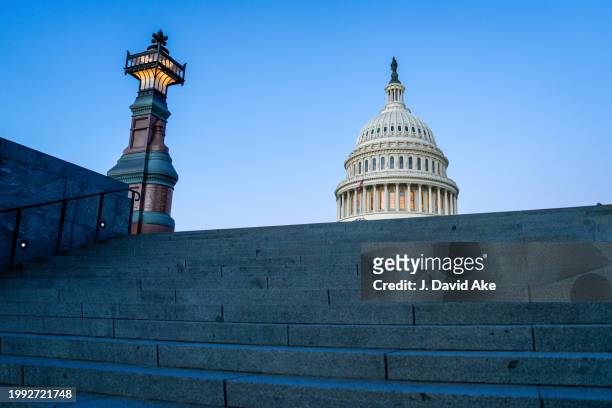 The US Capitol Dome peaks over the top of the visitor center stairs early in the morning on February 7 in Washington, DC.