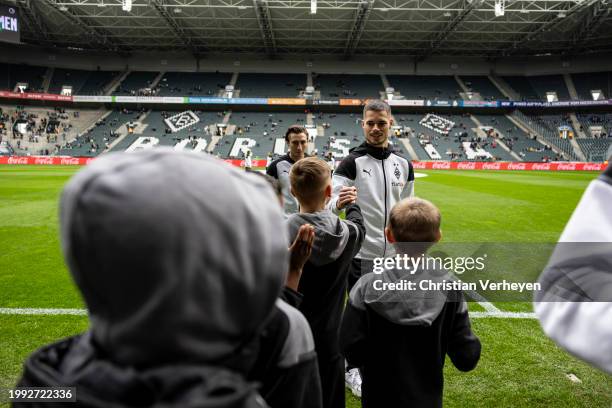 Julian Weigl of Borussia Moenchengladbach is seen with some kids ahead of the Bundesliga match between Borussia Moenchengladbach and SV Darmstadt 98...