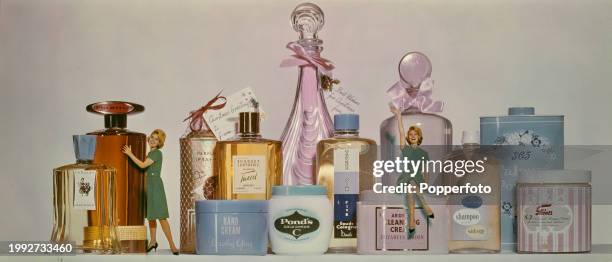 Montage studio image of a female fashion model reduced in size to pose with bottles, jars and containers of make up, perfumes, lotions, creams and...