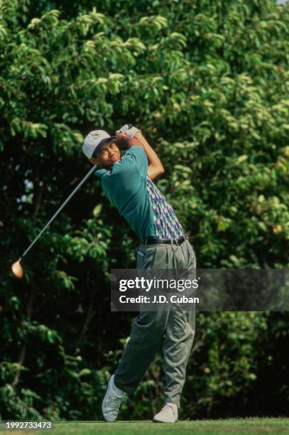 Tiger Woods from the United States follows his drive onto the fairway after teeing off during the United States Amateur Championship golf tournament...